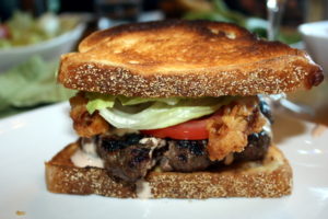 buttermilk onion rings on a burger