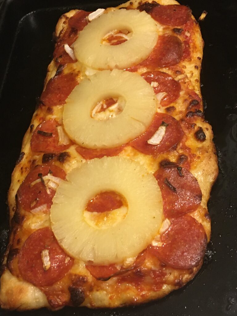 pizza with pepperoni and pineapple